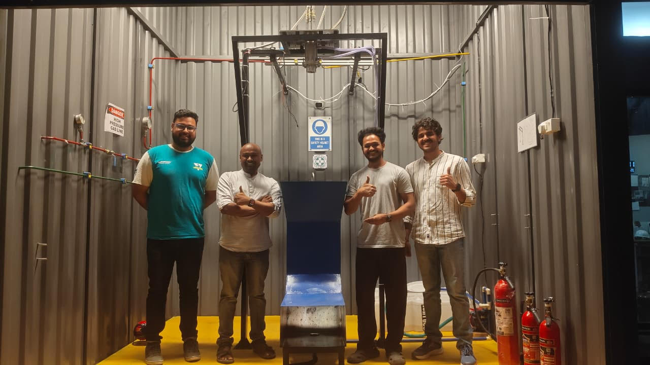 Recently, Vivek and team successfully carried out a static fire test in a specially built enclosure outside his lab (seen here). Apart from Dr Vishnu and Vivek (second and third from left), the team includes Tathagat Sarangi (first from left), a PhD student (MAE), and G Sai Harsh (fourth from left), an MTech student (MAE), who contributed to building the facility and setting up the experiment.